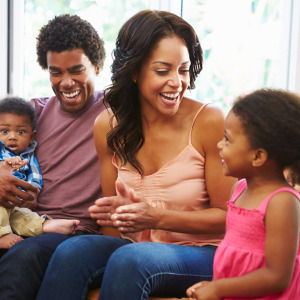 Family of four smiling and laughing together