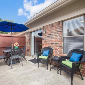 Private fenced patio of Galleria model home with patio furniture seating for 6
