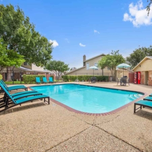 Galleria swimming pool with bright teal lounge furniture and bright blue skies